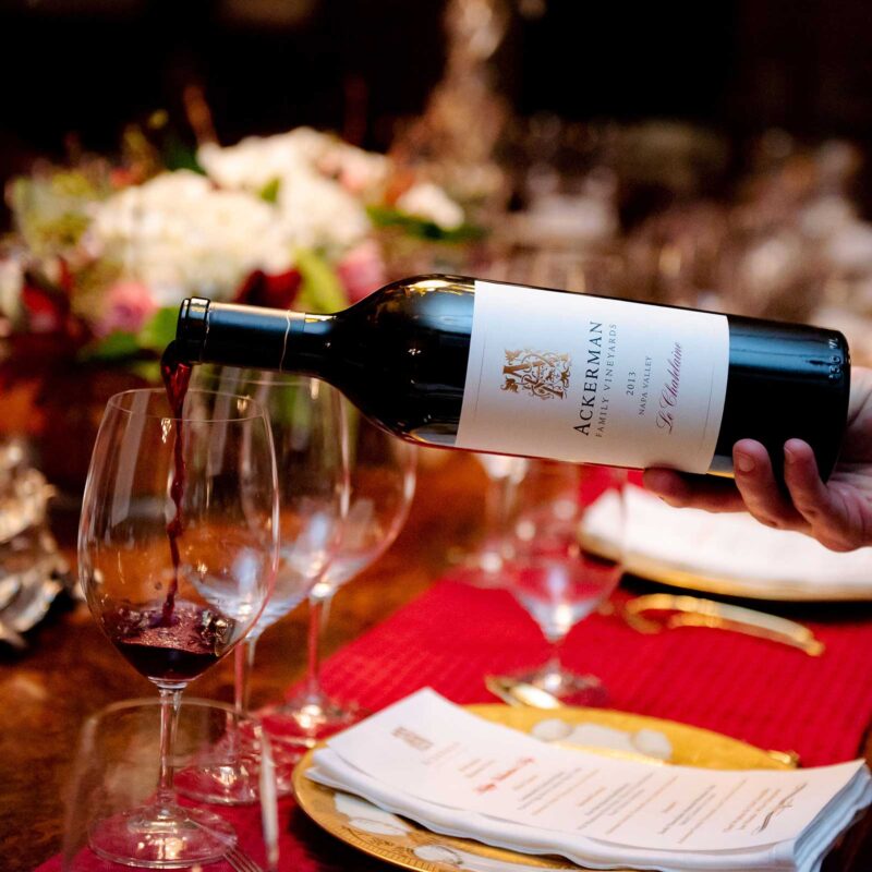 Ackerman wine being poured into glass at a dining table