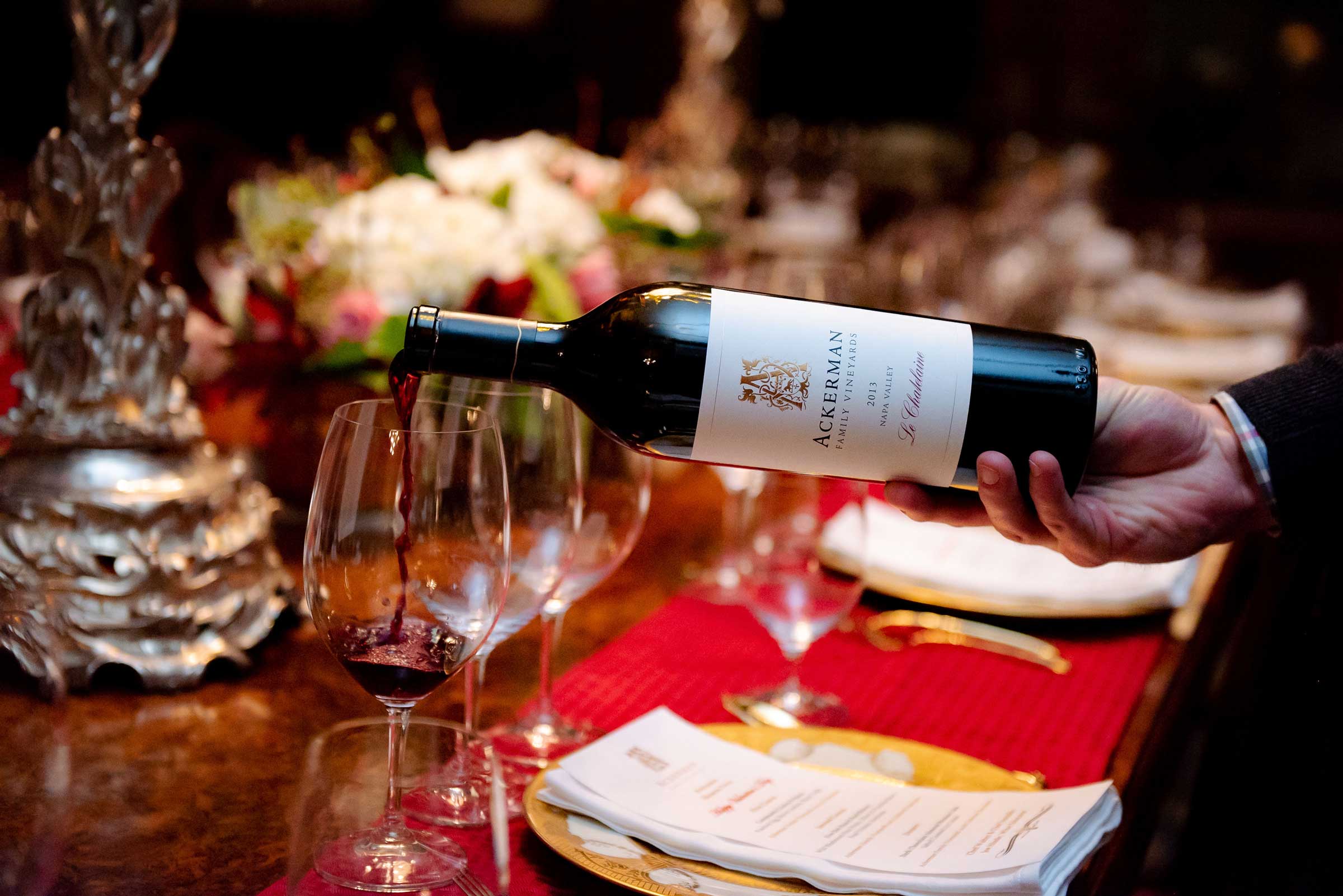 Ackerman wine being poured into glass at a dining table