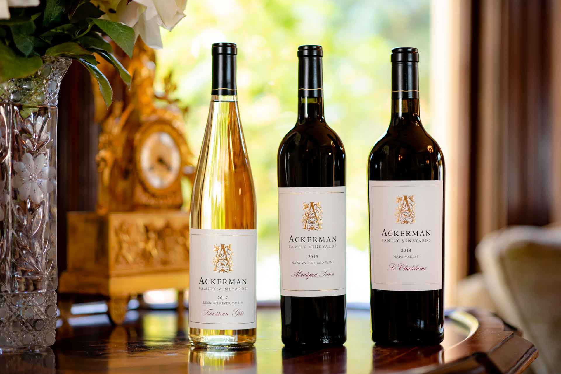 Trio of Ackerman wines beside a gold clock