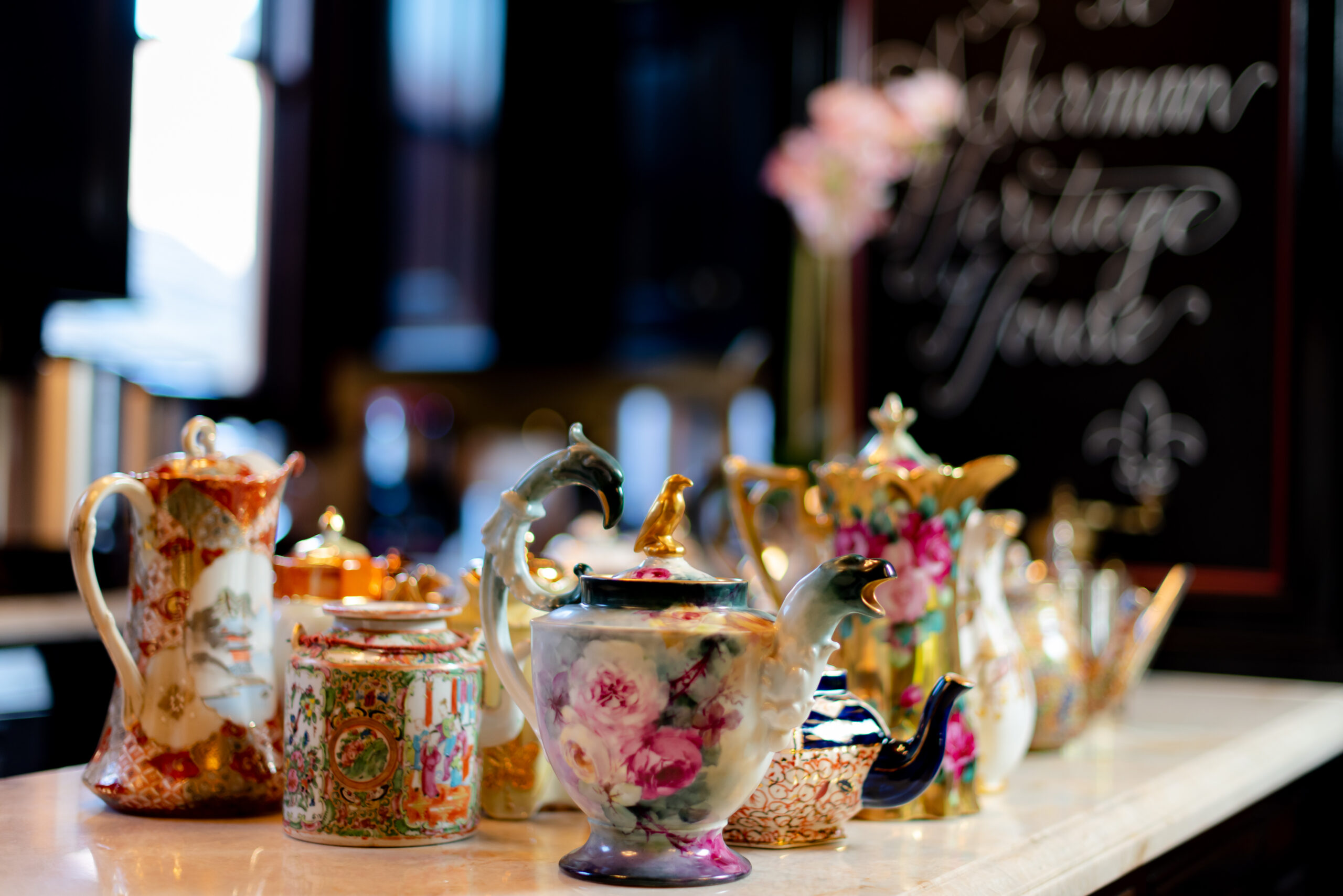 vintage tea set with florals painted on it